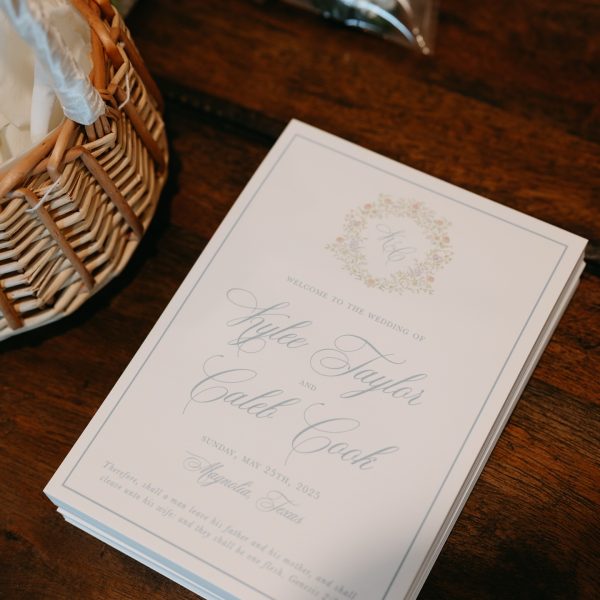 Elegant wedding program with floral monogram design