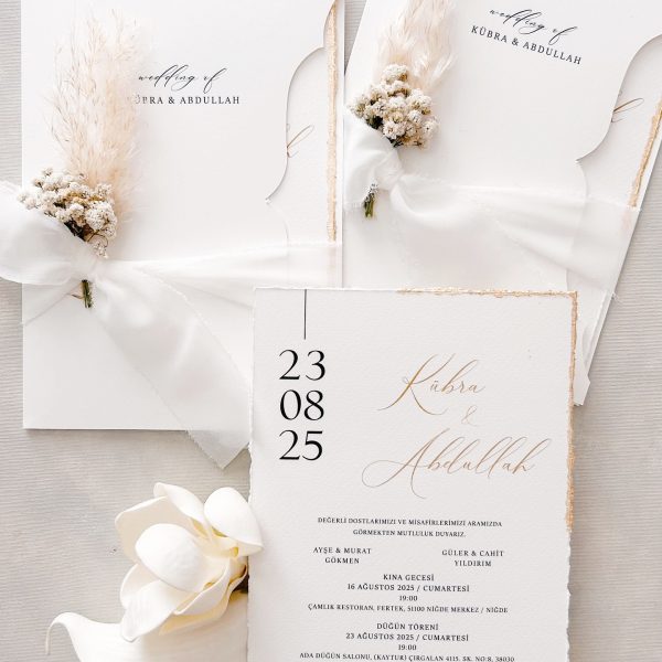 Minimalist white wedding invitation with floral accent