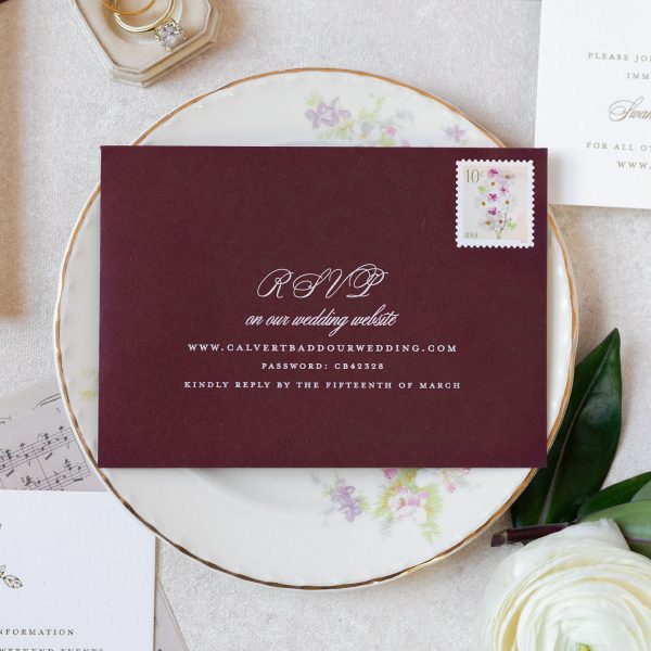 Burgundy RSVP envelope with elegant wedding calligraphy